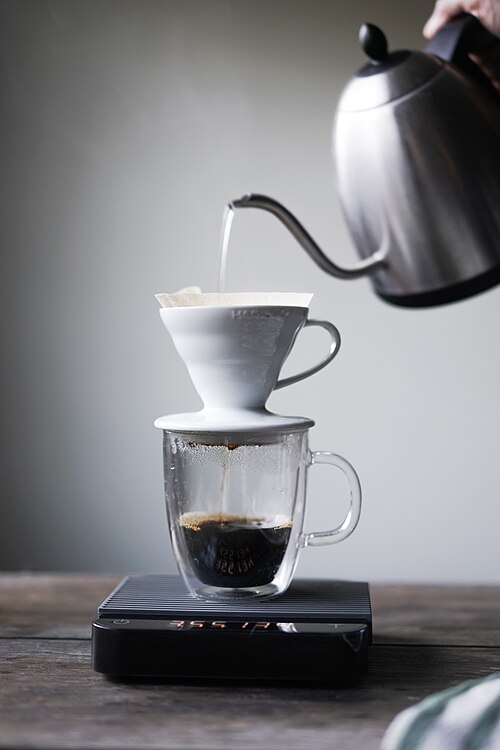 Gooseneck kettle pouring into V60 dripper on scale