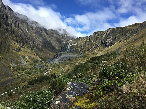 High Andean valley, cloud-draped slopes, trail
